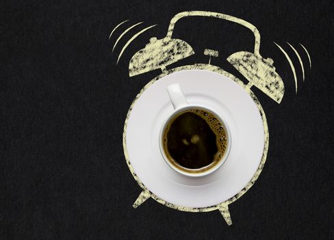 Creative concept photo of a coffee cup on a plate and illustrated alarm clock on black background.