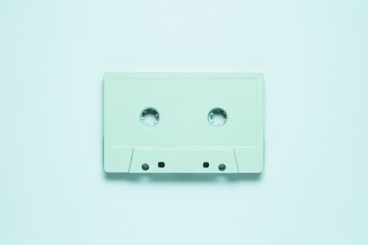 Creative photo of  painted cassette on mint background.