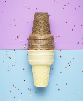 Creative photo of  two empty waffle cones on purple and blue background.