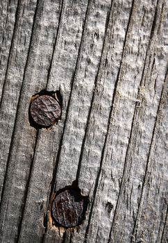 background or texture two rusty nails in wood