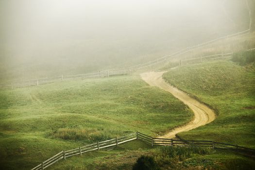 Foggy morning in a village on the hills of Carpathians