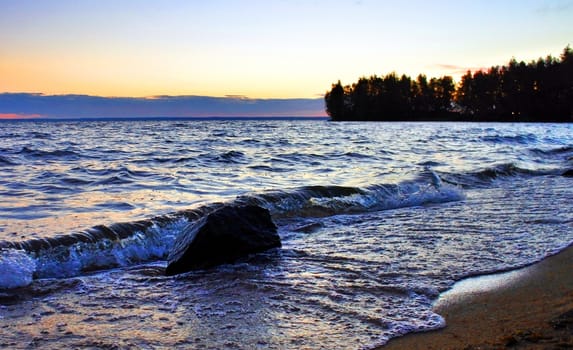 Beautiful sunrise on the lake in windy weather