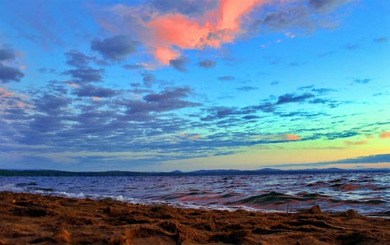 Beautiful sunrise on the lake in windy weather