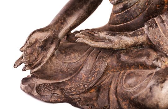 Buddha Shakyamuni's figure in a blessing pose - varada mudra. The old statue made of metal isolated on a white background.