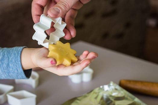 shortcrust dough in the shape of star for children's hand