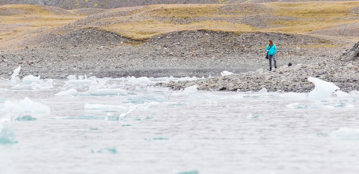 Woman walking over the beach at Jokulsarlon glacier lagoon in southern Iceland