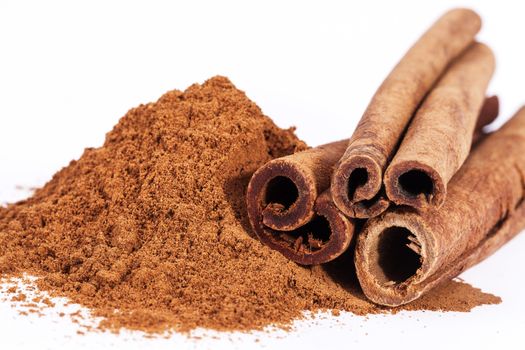 Cinnamon sticks and powder isolated on white background, close up.