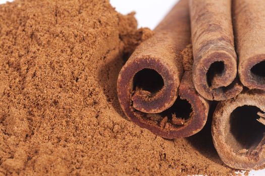 Cinnamon sticks and powder isolated on white background, close up.