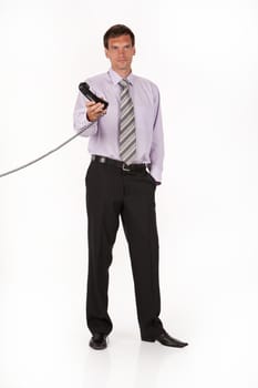 Young man in a business suit on an isolated studio background speaking over the phone