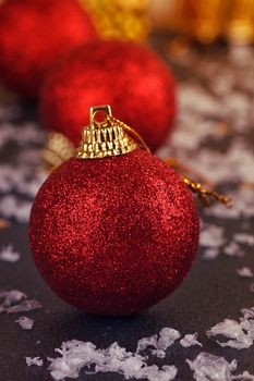 One red satin Christmas ball on black background