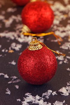 One red satin Christmas ball on black background