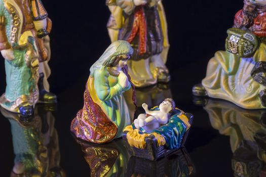 Christmas Manger scene with figurines including Jesus, Mary and magi. Focus on Mary!