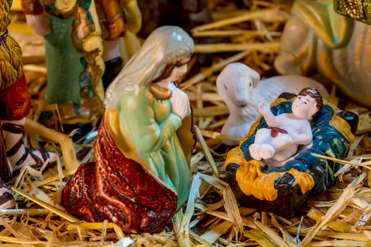 Christmas Manger scene with figurines including Jesus and Mary. Focus on baby Jesus!