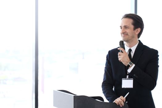 Business man speaking using microphone at conference