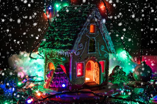 Gingerbread house with lights on dark background, xmas theme