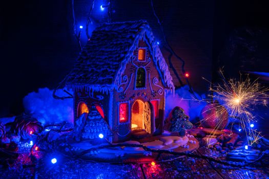 Gingerbread house with lights on dark background, xmas theme