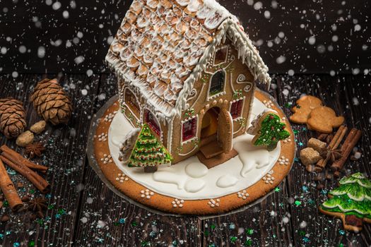 Homemade gingerbread house on dark background, xmas theme