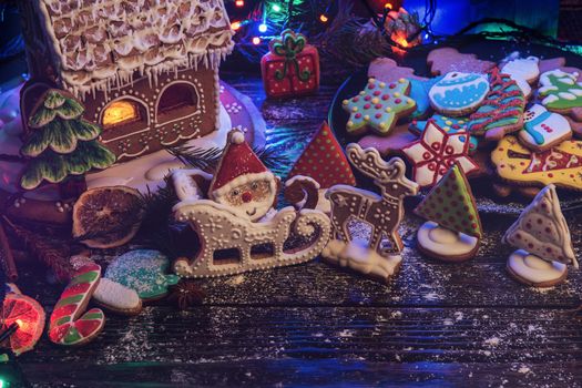 Gingerbreads for new years and christmas on wooden background, xmas theme