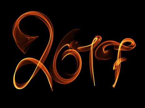 Happy new year 2017 isolated numbers lettering written with fire flame or smoke on black background.