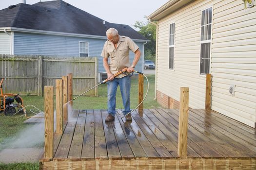 Contractor pressure washing deck , getting home ready to sell 