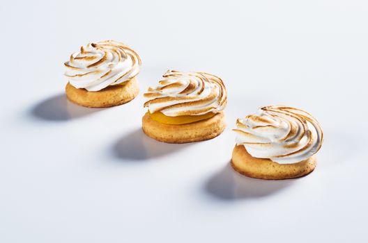 Round shortbread with cream on top on light background