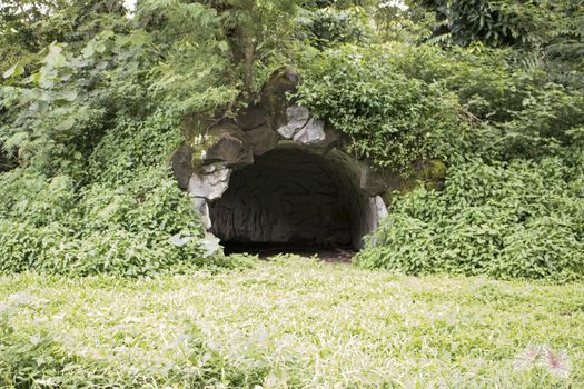 rock cave tunnel outdoor covered with grass dirt