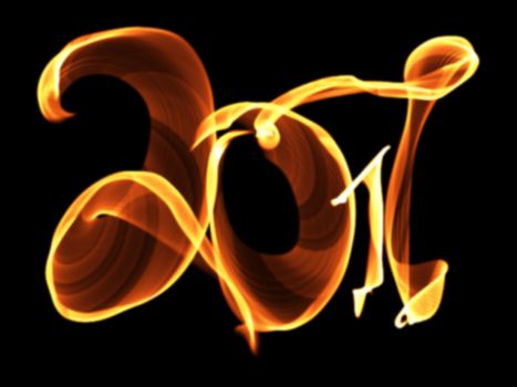 Happy new year 2017 isolated numbers lettering written with fire flame or smoke on black background.