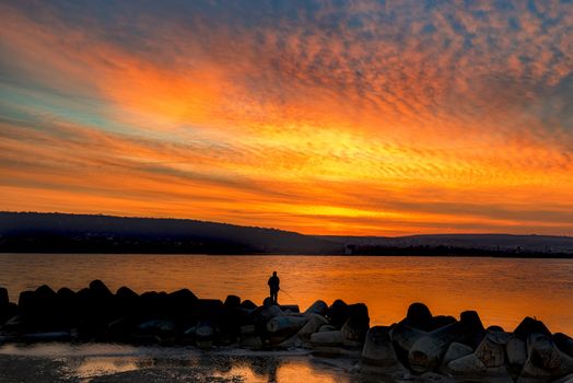 Fishing and fisherman in sea at amazing sunset