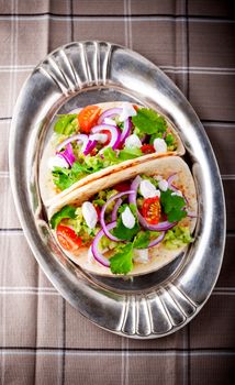 Chicken Tacos with vegetables served on the tray