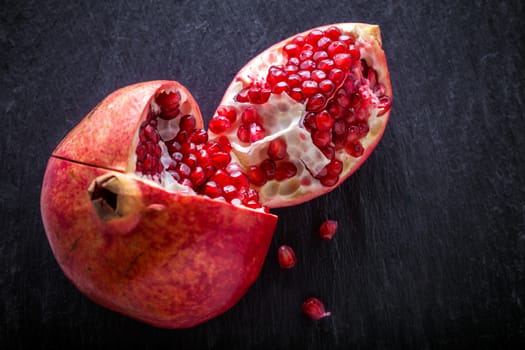 Fresh pomegranate placed on a stone plate