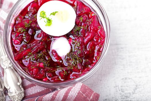 Bowl of beetroot soup with sour cream and eggs