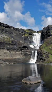 Reflection of Oferufoss waterfall, Eldgja gorge, Iceland