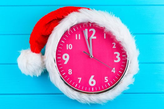 the pink clock with christmas santa hat