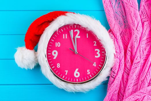 the pink clock with christmas santa hat