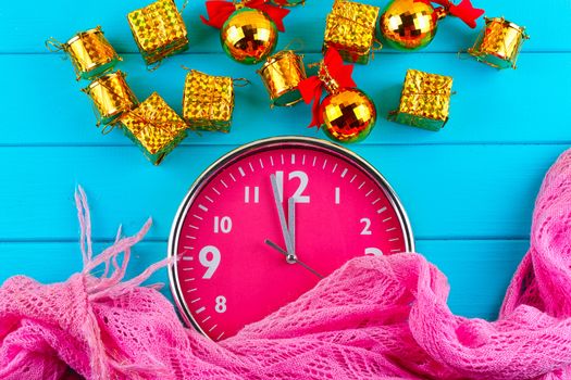 Fir tree with christmas decorations, alarm clock and gift boxes on blue background