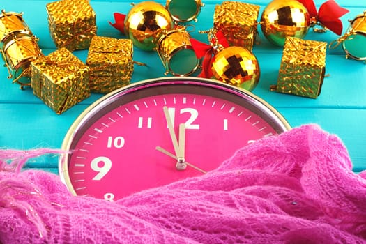 Fir tree with christmas decorations, alarm clock and gift boxes on blue background