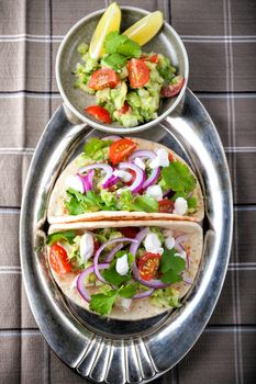 Chicken Tacos with vegetables served on the table.