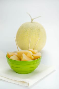 Ripe melon with slice on white background