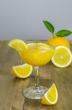 Orange juice and slices on wood