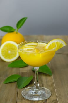 Fresh orange juice on wooden table over grunge background