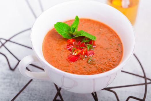 Bowl of fresh tomato soup gazpacho on the table