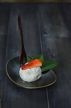 Strawberry Daifuku Mochi Japanese dessert on dish over wooden background , still life