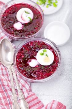 Bowl of beetroot soup with sour cream and eggs.