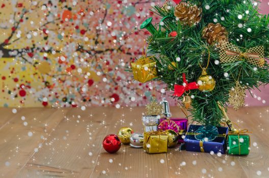 Christmas background with decorations and gift boxes on wooden board