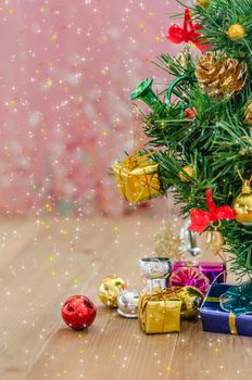 Christmas background with decorations and gift boxes on wooden board