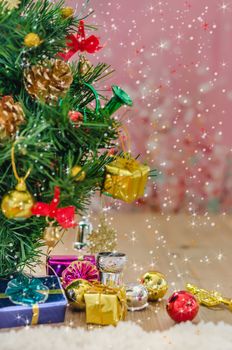 Christmas background with decorations and gift boxes on wooden board