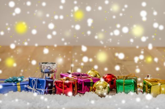 Christmas background with decorations and gift boxes on wooden board
