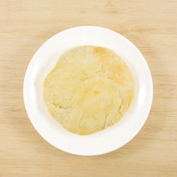 The Taiwanese sun cake (milk butter pastry) on the brown wooden plank.