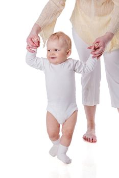 Mother holding daughter's hands first steps isolated on white