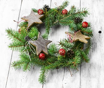 Noel wreath of fir branches decorated with Christmas toys